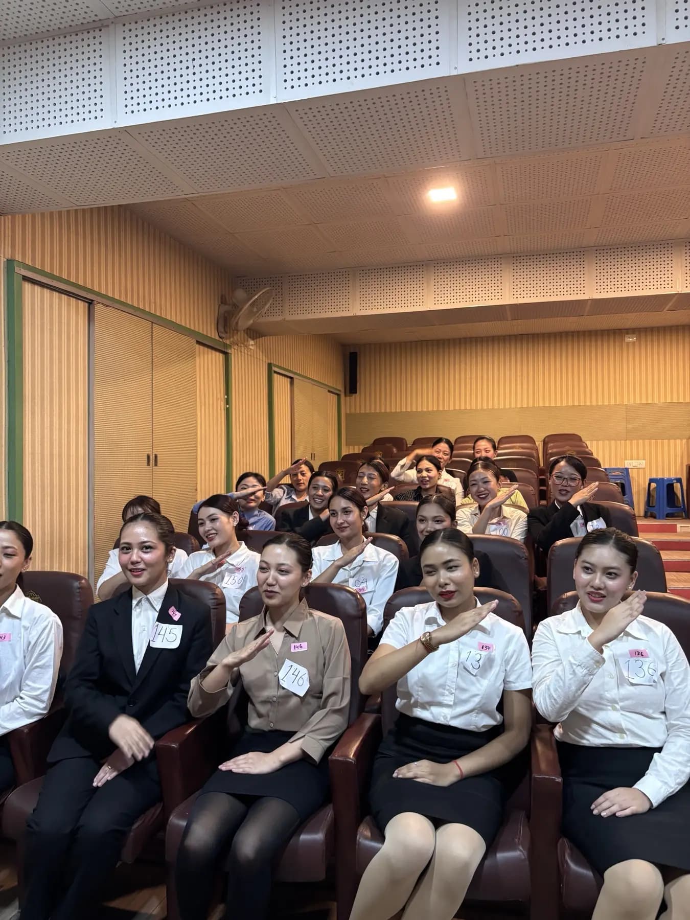A batch saluting in the auditorium
