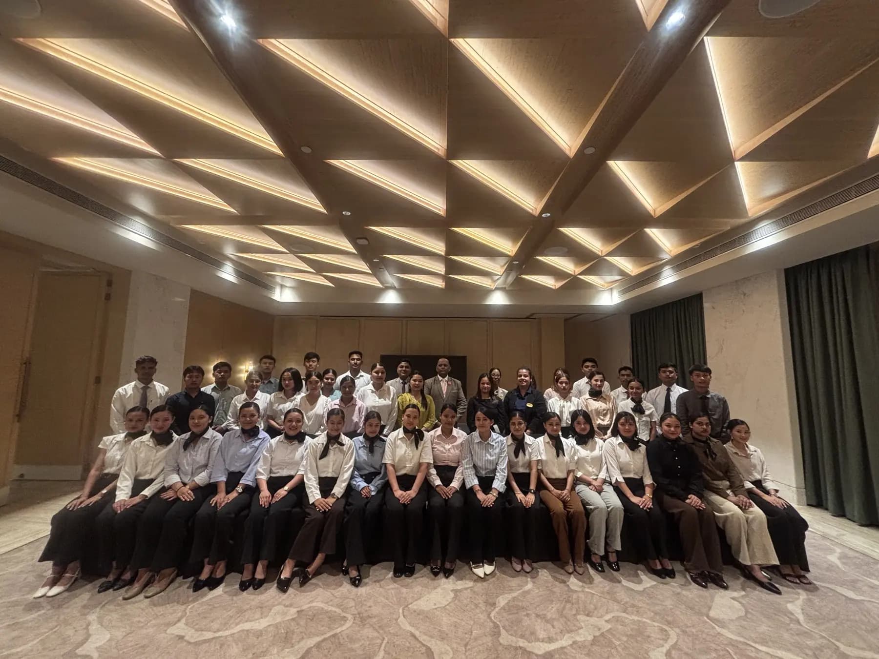 A full Emporium batch seated in a hotel ballroom